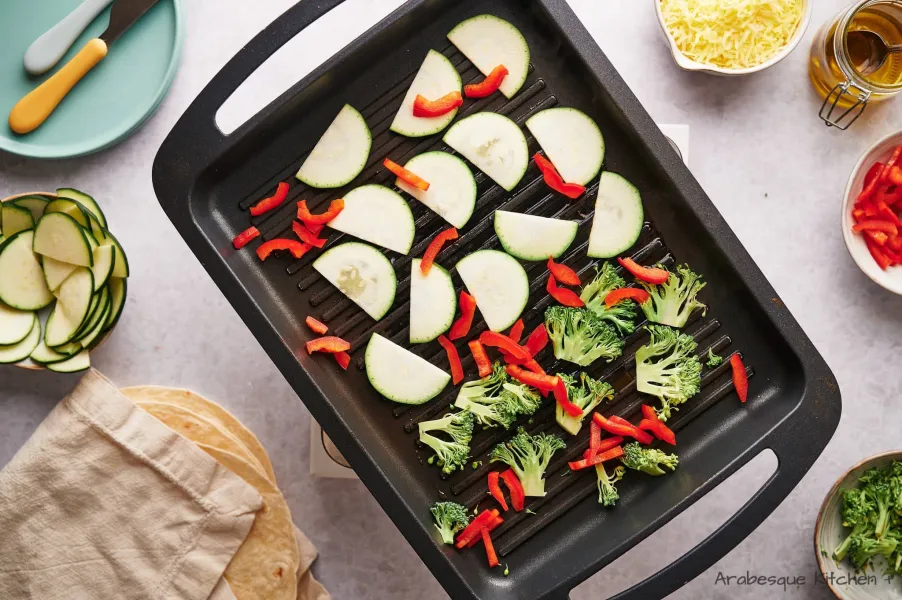 Heat a grill to medium-high and add the olive oil. Let it get hot and add the veggies in a single layer.