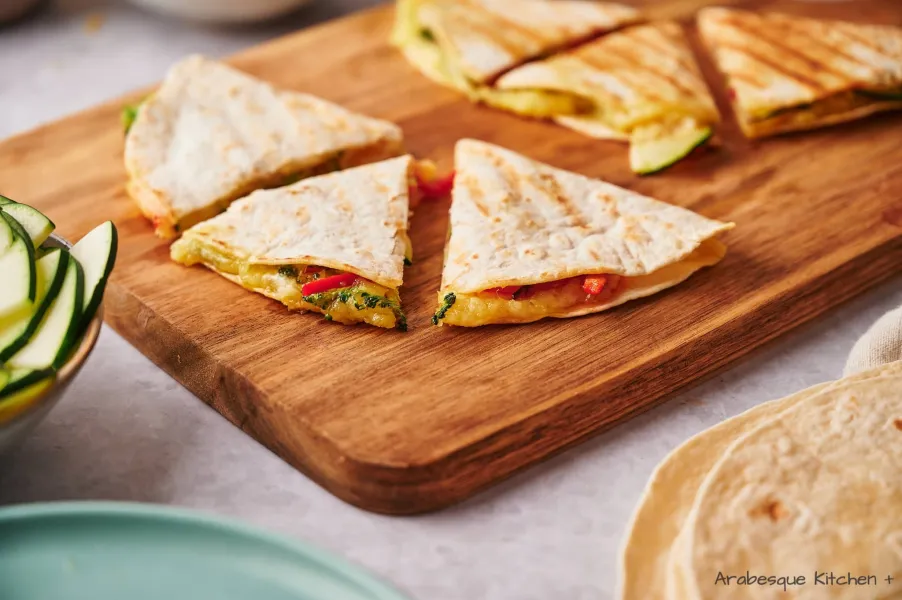 Cut the quesadillas in triangles and serve.
