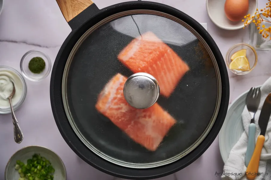 Once it is hot, place the salmon fillets, skin side down, cover the pan and let it cook until flaky (around 12 minutes, depending on the thickness of the fillets).
