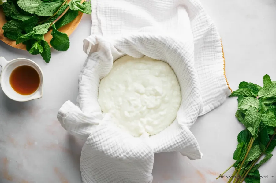 Couvrez un bol de cuisine profond avec une étamine ou un chiffon en mousseline et versez le yaourt.