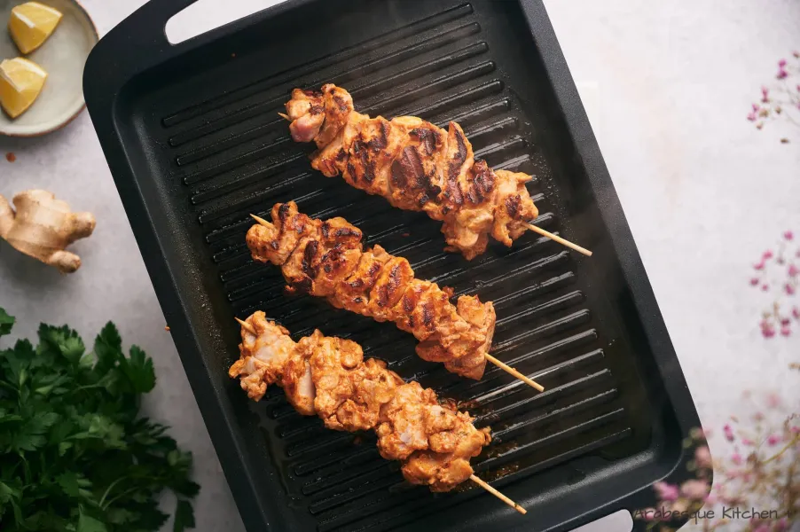 Thread the chicken in the skewers and grill them in a single layer until browned on every side (around 15 minutes).

