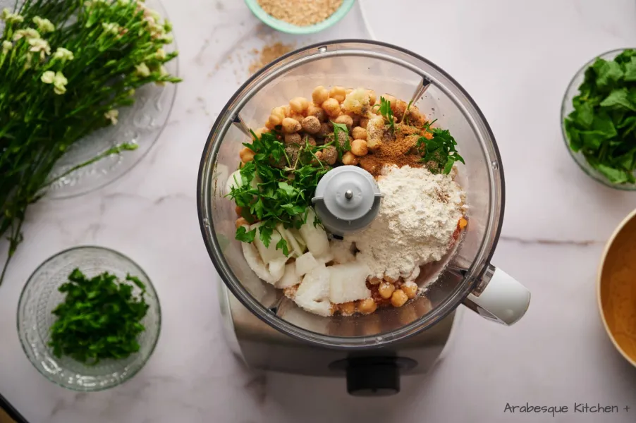 Transfer sweet potatoes, all-purpose flour, chickpeas, onion, garlic cloves, parsley, mint, ground cumin, lemon juice, salt and pepper to the bowl of a food processor and process until smooth.
