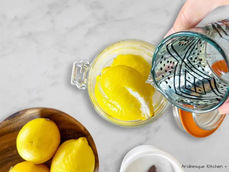 Remplissez le bocal avec autant de citrons que possible et utilisez-en un autre pour les citrons restants. Remplissez le bocal d'eau bouillante et fermez-le hermétiquement. 