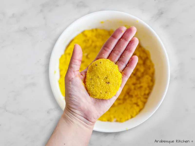 Use your hands to shape the dough into 2,5cm balls and flatten them to make 5cm large galettes. Transfer the galettes on a lined baking tray and place in the oven. Bake for 15 to 17 minutes until the galettes are firm and golden.

