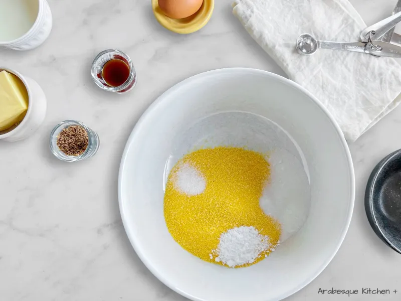 Melt the unsalted butter in a saucepan on medium-low heat and leave it to cool for 5 minutes. In a separate large bowl, transfer the melted butter, full-fat milk, egg, vanilla extract, and aniseeds. Use a whisk to stir all the ingredients together until well combined and smooth.