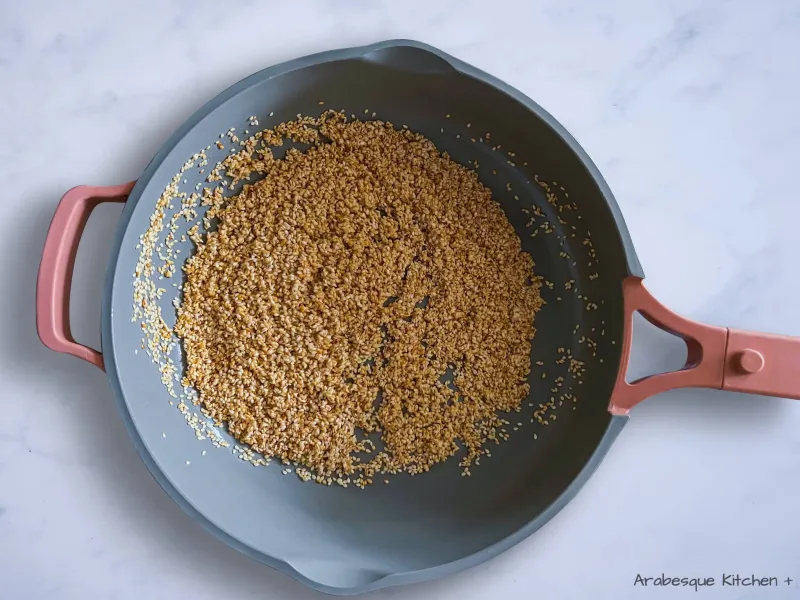 Cook the sesame seeds in a frying pan over medium-high heat without any added oil. Stir them regularly so they don’t burn. Set aside and leave to cool.
