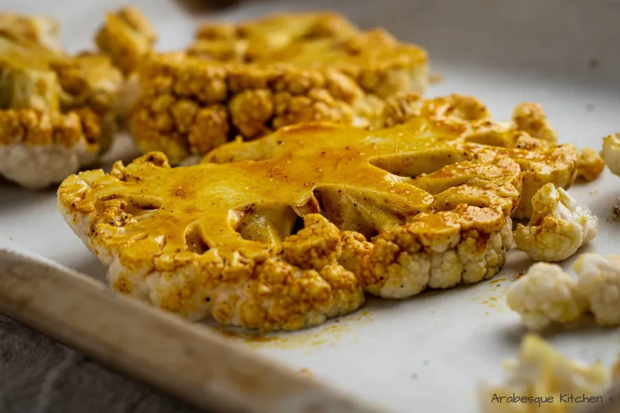 Brush the cauliflower steaks with the olive oil and spices combination and bake for 25-30 minutes or until browned.
