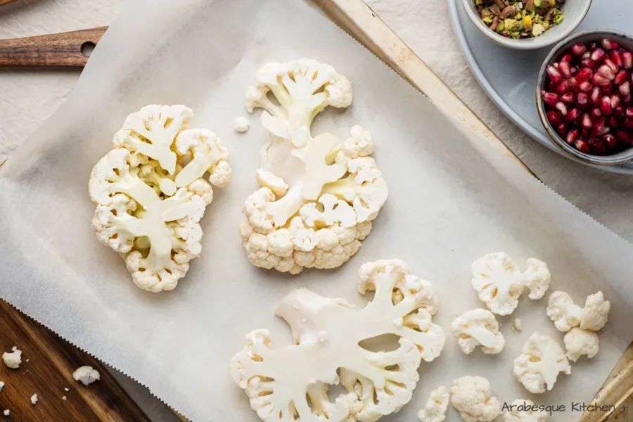 Line a baking tray with baking paper or foil and arrange the cauliflower steaks.

