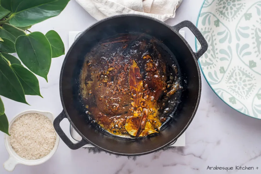In the same pot, add the rest of the ghee. Add paprika, ground coriander, turmeric, black pepper, cinnamon stick, bay leaves, cardamom pods, and ground cloves. Toast the spices for 2-3 minutes.
