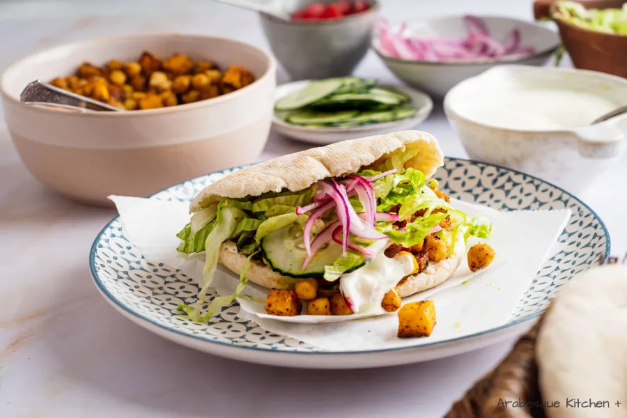 Serve the shawarmas with the pita bread pockets, lettuce, tomatoes, pickled onions, cucumber, celeriac and chickpeas.
