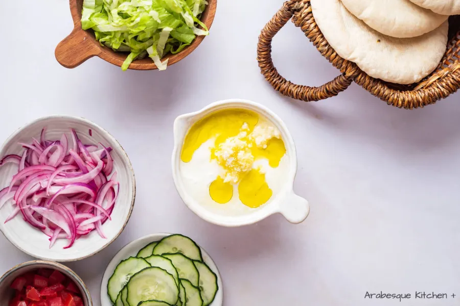 Make the yogurt sauce by combining yogurt, lemon, garlic, olive oil, and salt.
