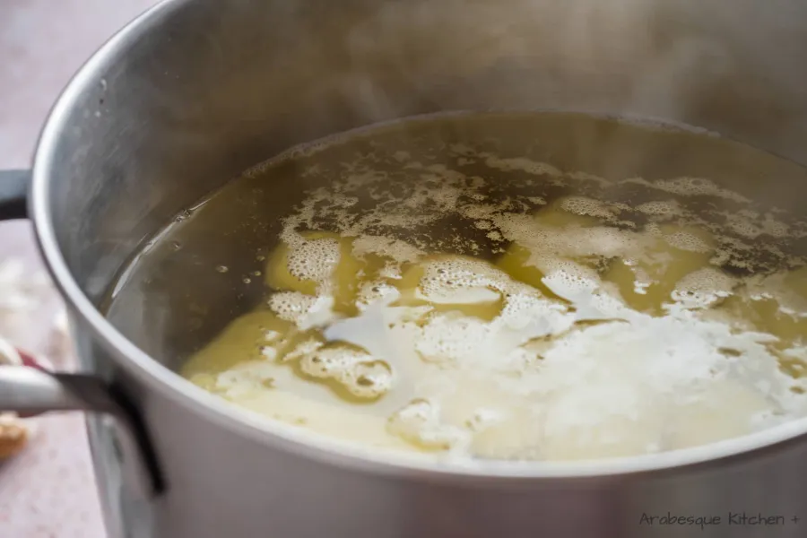 Bring a large pot of water to boil and add the salt and peeled potatoes.
