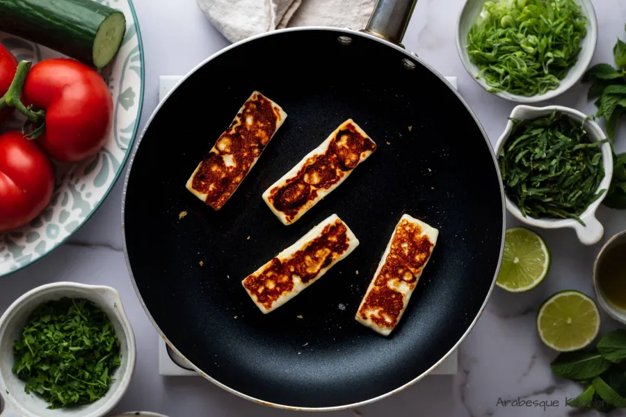 Cook the halloumi slices until browned on both sides. Reserve.

