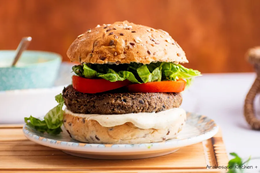 To assemble the burgers: Heat the buns in the grill and layer sauce, patties, tomato slices and lettuce.