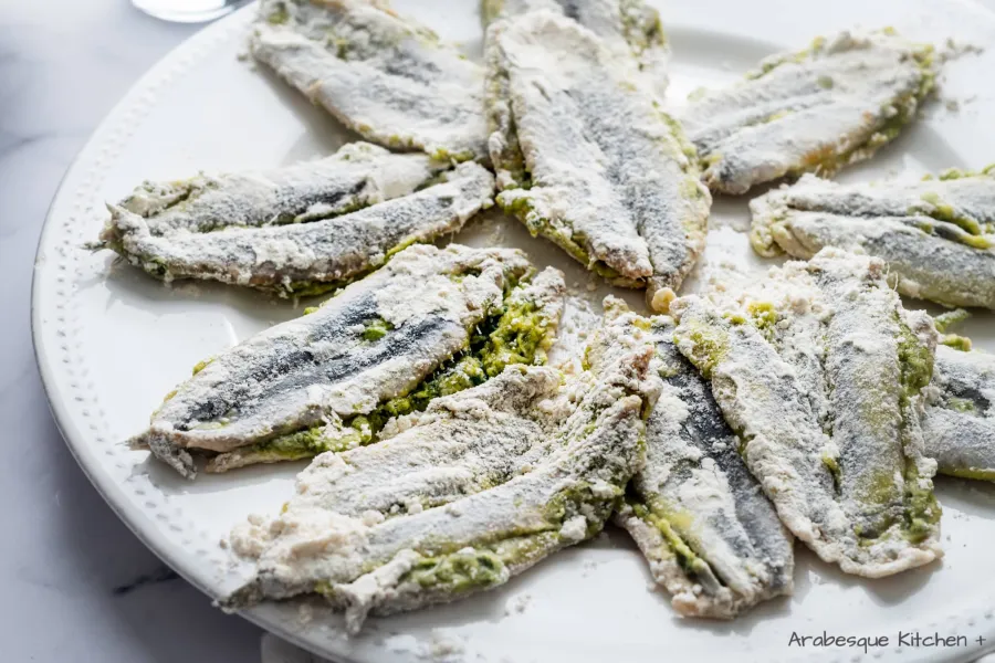 Heat the oil to 180ºC/360ºF in a small pan and cover the sardines in the flour.

