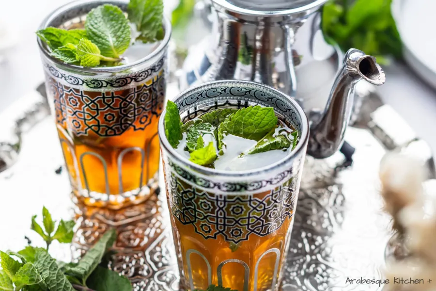 Add spirit, boiling water, sugar and mint. Close the tea pot and let it rest for 2 minutes. Serve in cups with more mint.

