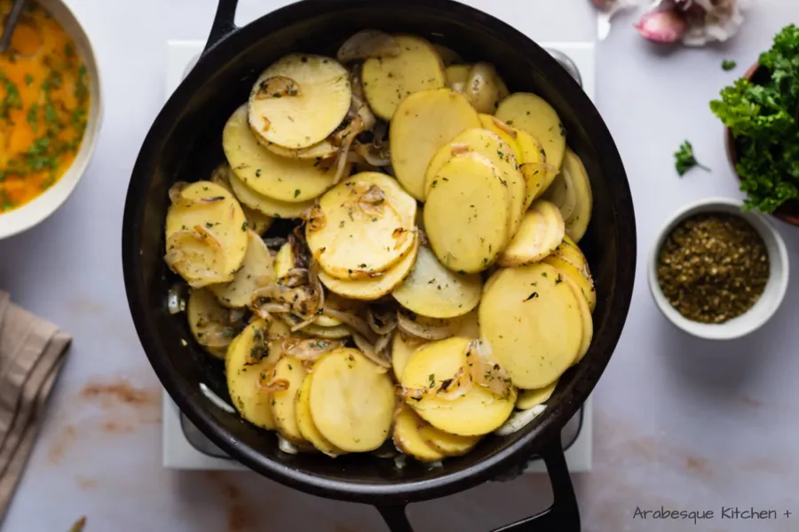Add the potatoes, along with ½ cup of water and cook them for around 10 minutes, trying to move them without breaking them with the help of a wooden spatula.
